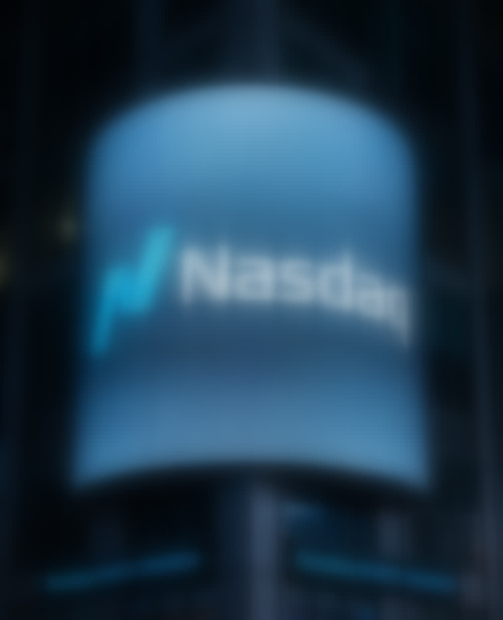 The curved LED screen of the Nasdaq MarketSite tower at night.