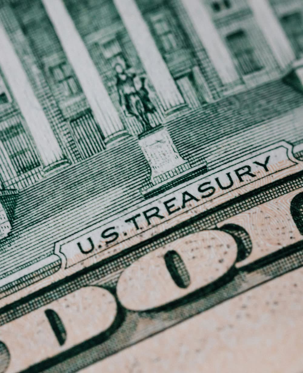 Engraved intaglio detail from a United States banknote, reading U.S. TREASURY.